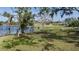 Landscaped waterfront lot with mature trees and lake views at 8006 Oak Dr, Palmetto, FL 34221