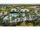 Community pool with clubhouse and surrounding landscaping at 8684 Canyon Creek Trl, Parrish, FL 34219