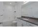 Bathroom with tub, toilet and vanity with dark countertop at 8684 Canyon Creek Trl, Parrish, FL 34219