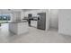 Modern kitchen with stainless steel appliances, an island, and white cabinets at 8684 Canyon Creek Trl, Parrish, FL 34219