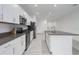 Modern kitchen with stainless steel appliances, an island, and white cabinets at 8684 Canyon Creek Trl, Parrish, FL 34219