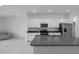 Modern kitchen with stainless steel appliances, an island, and white cabinets at 8684 Canyon Creek Trl, Parrish, FL 34219