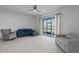 Bright living room with sliding glass doors leading to a patio and view of a pond at 8684 Canyon Creek Trl, Parrish, FL 34219