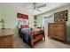 Cozy bedroom with a wooden bed frame, dresser, and ceiling fan at 9066 Oneal Ave, New Port Richey, FL 34654
