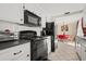 Modern kitchen with black appliances and white cabinets at 9066 Oneal Ave, New Port Richey, FL 34654