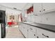 White cabinets, black appliances and a view into the dining area at 9066 Oneal Ave, New Port Richey, FL 34654