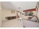 Living room with tiled floors, sofa, and a wooden cabinet at 9066 Oneal Ave, New Port Richey, FL 34654