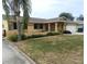 House exterior features a well-manicured lawn, a driveway and a gated entrance at 9400 Ridge Rd, Seminole, FL 33772