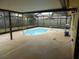 Screened-in pool area with concrete decking at 9400 Ridge Rd, Seminole, FL 33772