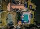 Aerial view of community pool, tennis courts, and clubhouse near a lake at 9481 Highland Oak Dr # 1403, Tampa, FL 33647