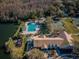 Community pool, tennis courts, playground, and clubhouse are shown in this aerial view at 9481 Highland Oak Dr # 1403, Tampa, FL 33647