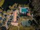 Aerial view of community amenities including pool, tennis courts, playground, and clubhouse at 9481 Highland Oak Dr # 1403, Tampa, FL 33647