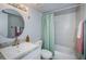 Clean bathroom with a tub, shower, and updated vanity at 9481 Highland Oak Dr # 1403, Tampa, FL 33647