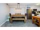 Dining area with a rustic wooden table and bench, adjacent to kitchen at 9481 Highland Oak Dr # 1403, Tampa, FL 33647