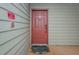 Condo building entry door with a welcome mat at 9481 Highland Oak Dr # 1403, Tampa, FL 33647