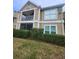 Tan two-story building with balcony and manicured landscaping at 9481 Highland Oak Dr # 1403, Tampa, FL 33647