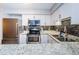 Modern kitchen with stainless steel appliances and granite countertops at 9481 Highland Oak Dr # 1403, Tampa, FL 33647