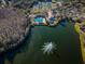 Aerial view of community lake with fountain and nearby amenities including pool and clubhouse at 9481 Highland Oak Dr # 1403, Tampa, FL 33647