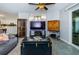 Living room features a large TV, comfortable seating, and access to kitchen at 9481 Highland Oak Dr # 1403, Tampa, FL 33647