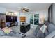 Bright living room with comfy seating, large TV, and sliding glass doors to patio at 9481 Highland Oak Dr # 1403, Tampa, FL 33647