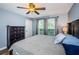 Spacious main bedroom with king bed, ceiling fan, and window with blinds at 9481 Highland Oak Dr # 1403, Tampa, FL 33647