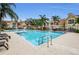 Refreshing community pool with lounge chairs and palm trees at 9481 Highland Oak Dr # 1403, Tampa, FL 33647