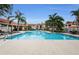 Inviting community pool area with ample lounge chairs at 9481 Highland Oak Dr # 1403, Tampa, FL 33647