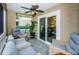 Relaxing screened porch with wicker furniture and ceiling fan at 9481 Highland Oak Dr # 1403, Tampa, FL 33647