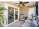Cozy screened porch with wicker furniture and sliding glass doors at 9481 Highland Oak Dr # 1403, Tampa, FL 33647
