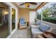 Screened porch with wicker furniture and access to the outdoors at 9481 Highland Oak Dr # 1403, Tampa, FL 33647