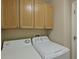 Bright laundry room with washer, dryer, and ample cabinets at 9606 Sea Turtle Ter # 101, Bradenton, FL 34212