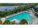 Community pool with lounge chairs and waterfront view at 9606 Sea Turtle Ter # 101, Bradenton, FL 34212
