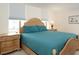 Bedroom with wicker bed frame and teal bedding at 101 S Gulfstream Ave # 10E, Sarasota, FL 34236