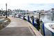 Boats docked at a marina with a walkway alongside at 101 S Gulfstream Ave # 10E, Sarasota, FL 34236