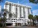 Modern condo building exterior with parking and American flag at 101 S Gulfstream Ave # 10E, Sarasota, FL 34236