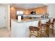 Modern kitchen with light wood cabinets, granite counters, and stainless steel appliances at 101 S Gulfstream Ave # 10E, Sarasota, FL 34236