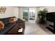 Living room with comfortable seating, large TV, and balcony access at 101 S Gulfstream Ave # 10E, Sarasota, FL 34236