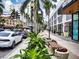 Upscale street scene with shops, palm trees, and pedestrian walkway at 101 S Gulfstream Ave # 10E, Sarasota, FL 34236