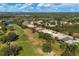 Aerial view of community with houses, golf course, and lush landscape at 10114 Glenmore Ave, Bradenton, FL 34202