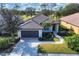 One-story house with a dark brown tile roof, and a nicely landscaped yard at 10114 Glenmore Ave, Bradenton, FL 34202