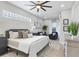 King-size bed in a well-lit bedroom featuring hardwood floors and sitting area at 10114 Glenmore Ave, Bradenton, FL 34202