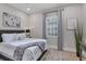Comfortable guest bedroom with a queen-size bed and a window with shutters at 10114 Glenmore Ave, Bradenton, FL 34202