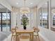 Bright dining area with light wood table and chairs, overlooking a pool and golf course at 10114 Glenmore Ave, Bradenton, FL 34202