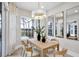 Dining area with light wood table and chairs, overlooking a pool and golf course at 10114 Glenmore Ave, Bradenton, FL 34202