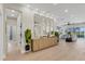 Modern entryway with light wood floors, a console table, and mirrors reflecting the living area at 10114 Glenmore Ave, Bradenton, FL 34202