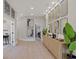 Light and airy entryway with wood flooring, a console table, and a gallery wall of mirrors at 10114 Glenmore Ave, Bradenton, FL 34202