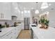 Modern kitchen with white cabinets, stainless steel appliances, and a large island at 10114 Glenmore Ave, Bradenton, FL 34202