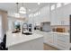 Modern white kitchen with stainless steel appliances and quartz countertops at 10114 Glenmore Ave, Bradenton, FL 34202
