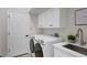 Bright laundry room with white cabinets and modern appliances at 10114 Glenmore Ave, Bradenton, FL 34202