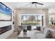Living room features a fireplace and sliding doors opening to a pool and golf course view at 10114 Glenmore Ave, Bradenton, FL 34202